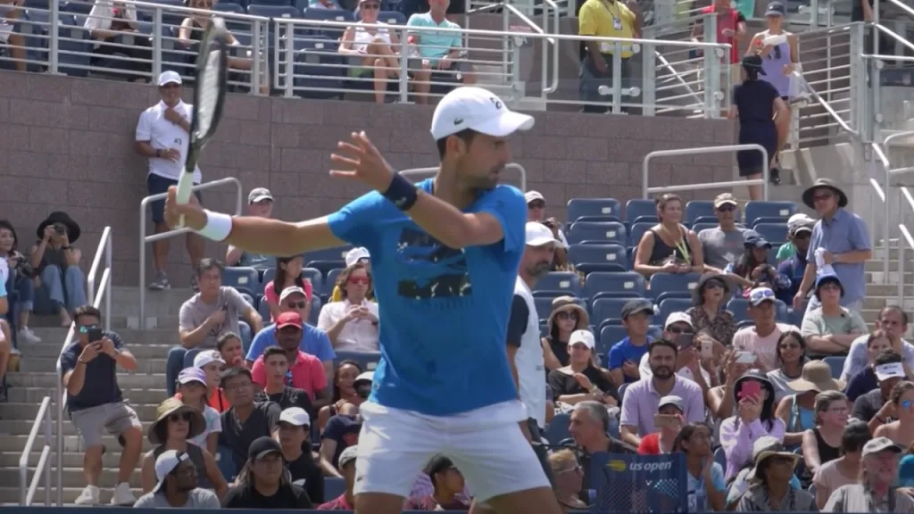 Novak Djokovic completing a forehand unit turn with racket back and non-dominant shoulder pointing at the ball