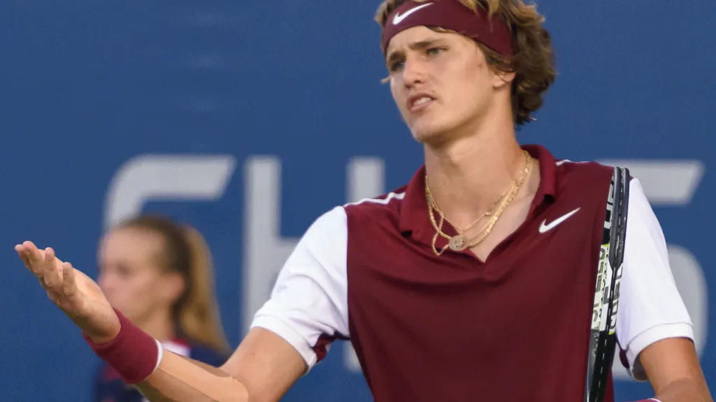 A tennis player managing frustration between points