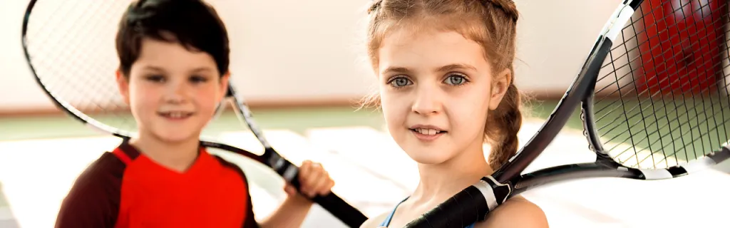 Children playing tennis on court