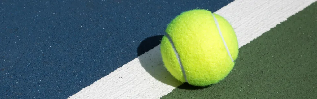 close-up of a tennis ball on the court line