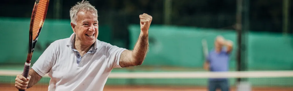 Tennis players competing in doubles, demonstrating the social benefits of the sport