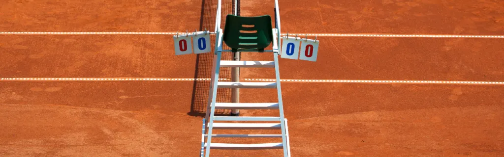 tennis umpire chair on a clay court